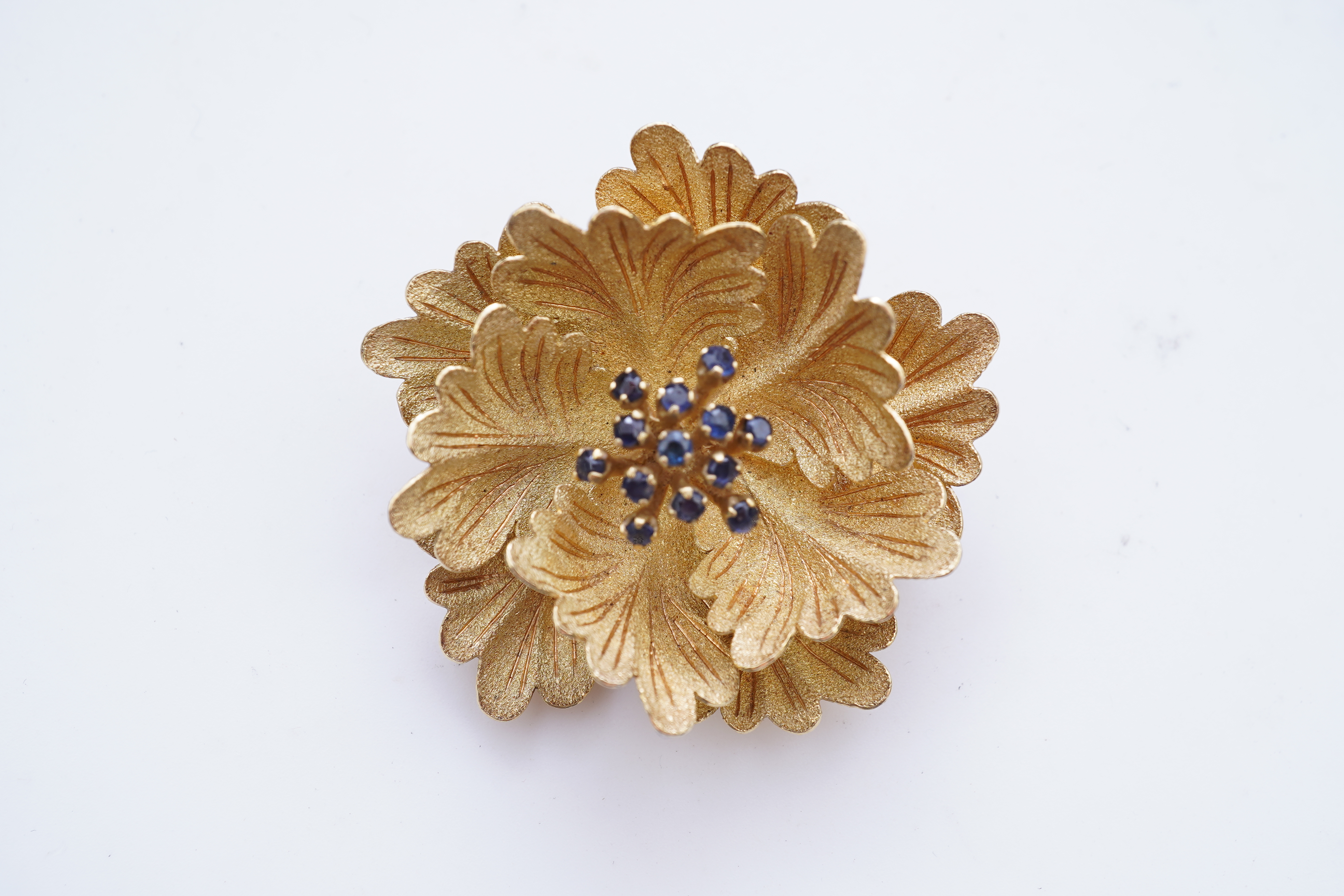 A gold and sapphire brooch, third quarter 20th century